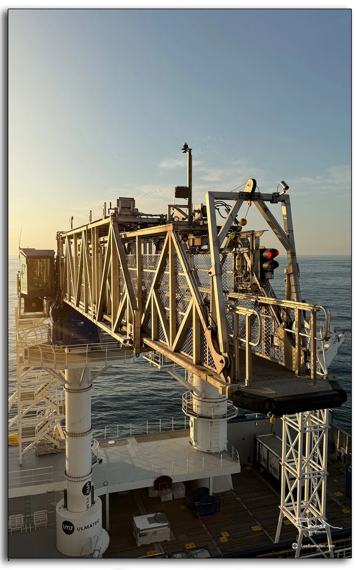 Walk-to-Work bridge structure photographed at sunrise, cab and steel truss detail highlighted.