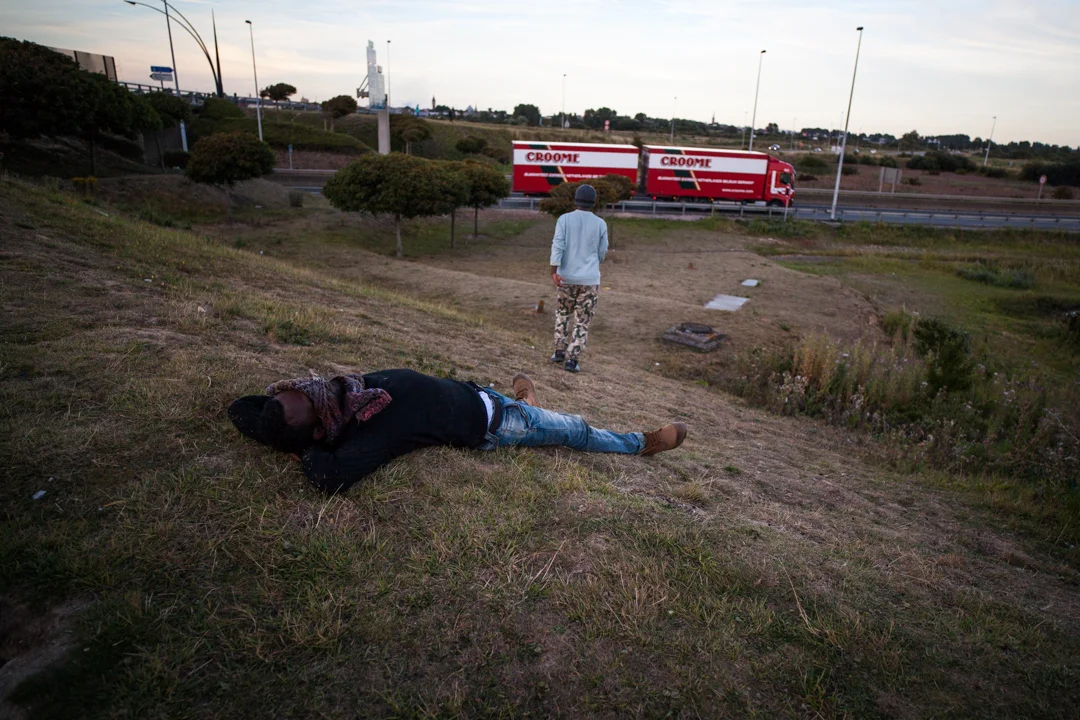 Certains migrants sont exténués. Ils essaient de passer chaque soir. En attendant la nuit, ils économisent leur énergie. L'Humanité - 10.08.15