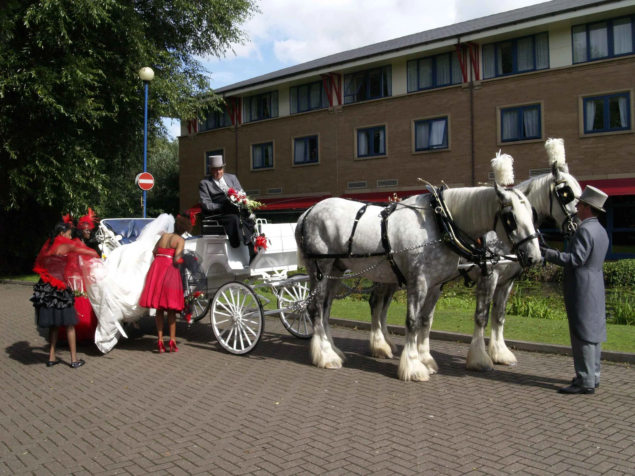 All hands on deck to get my huge dress on the carriage 