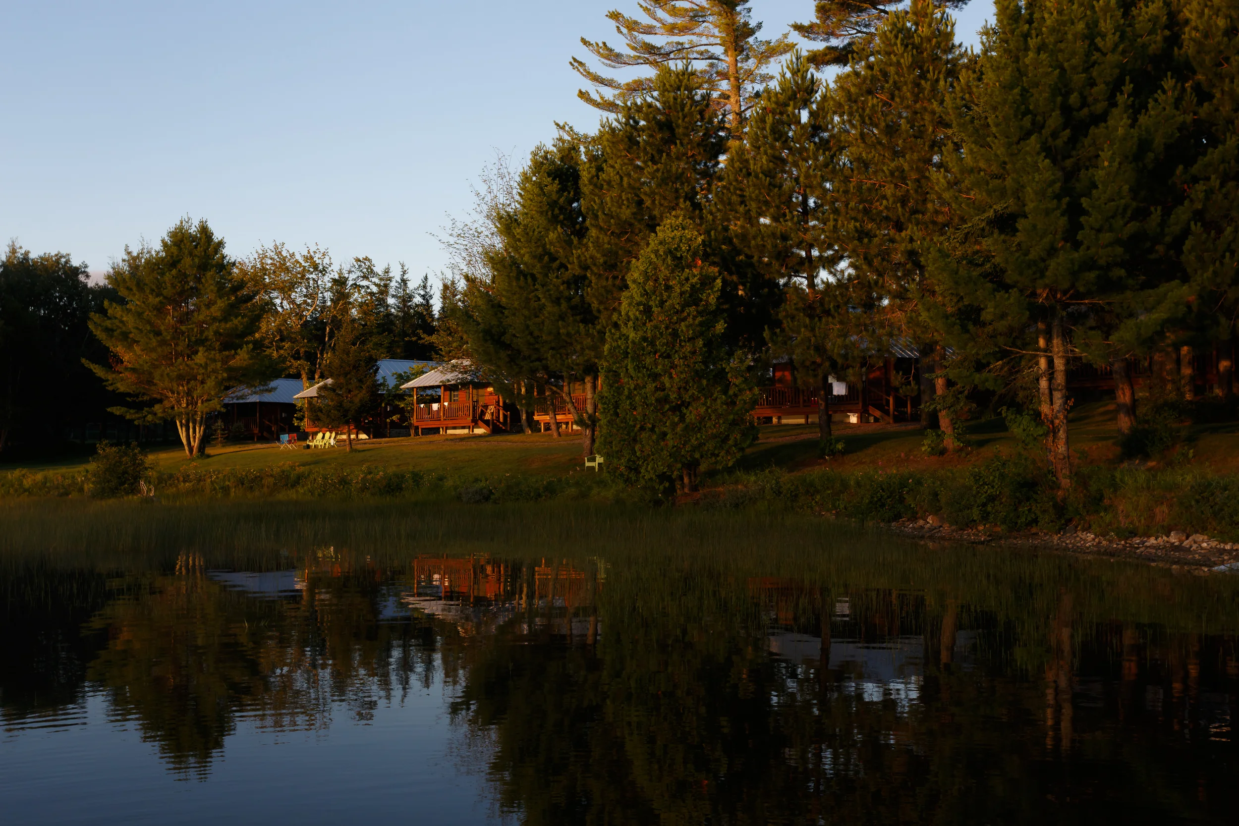 Row of 6 log cabins.