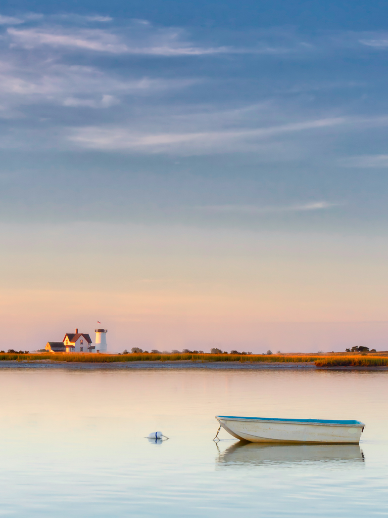 I made the lighthouse a little bigger and moved it to the left side of the image to balance with the small boat. I also cloned out everything in the water so the focus would stay on the boat and the lighthouse. 