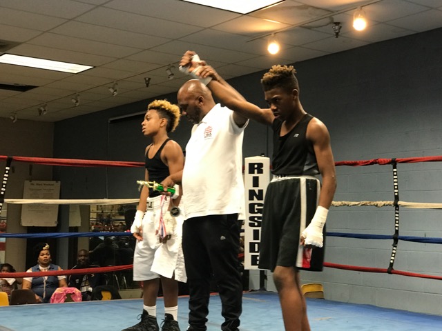 Jake Plamer Getting his hand raised in Victory.