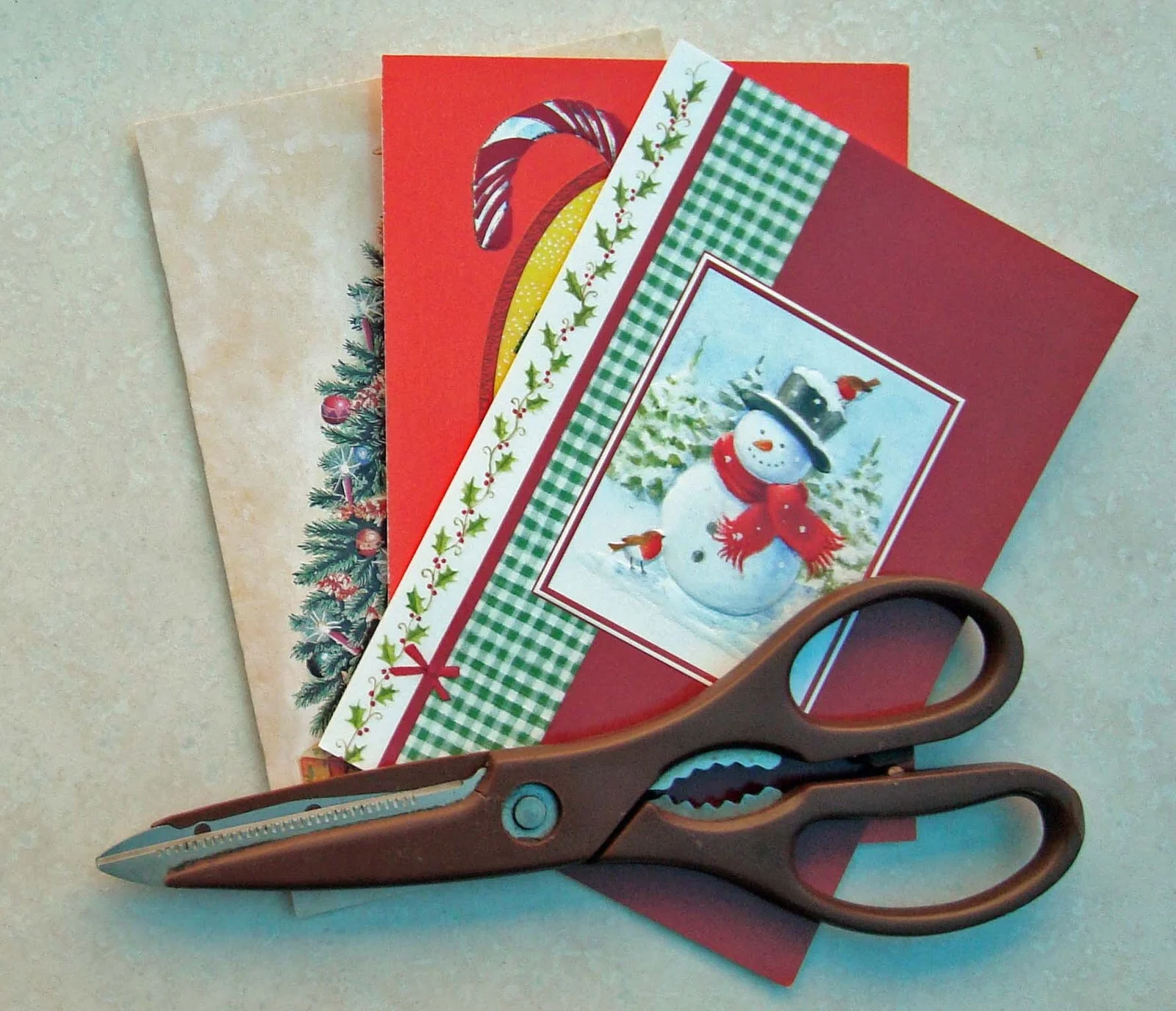 Cutting out pictures from old cards to make gift tags.