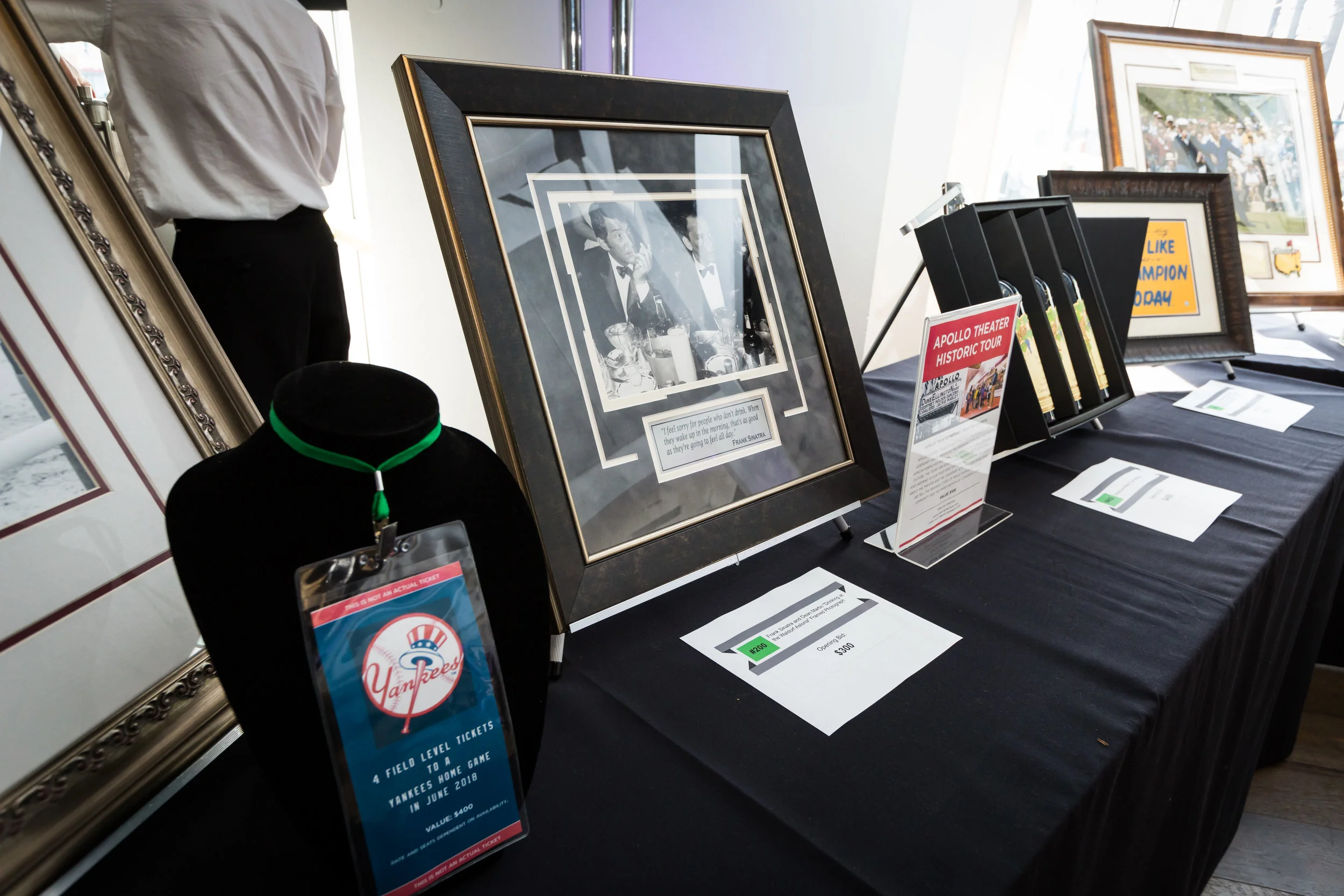 Auction Items: 4 field level tickets to the yankees, framed photograph of Frank Sinatra, Apollo Theater Historic Tour