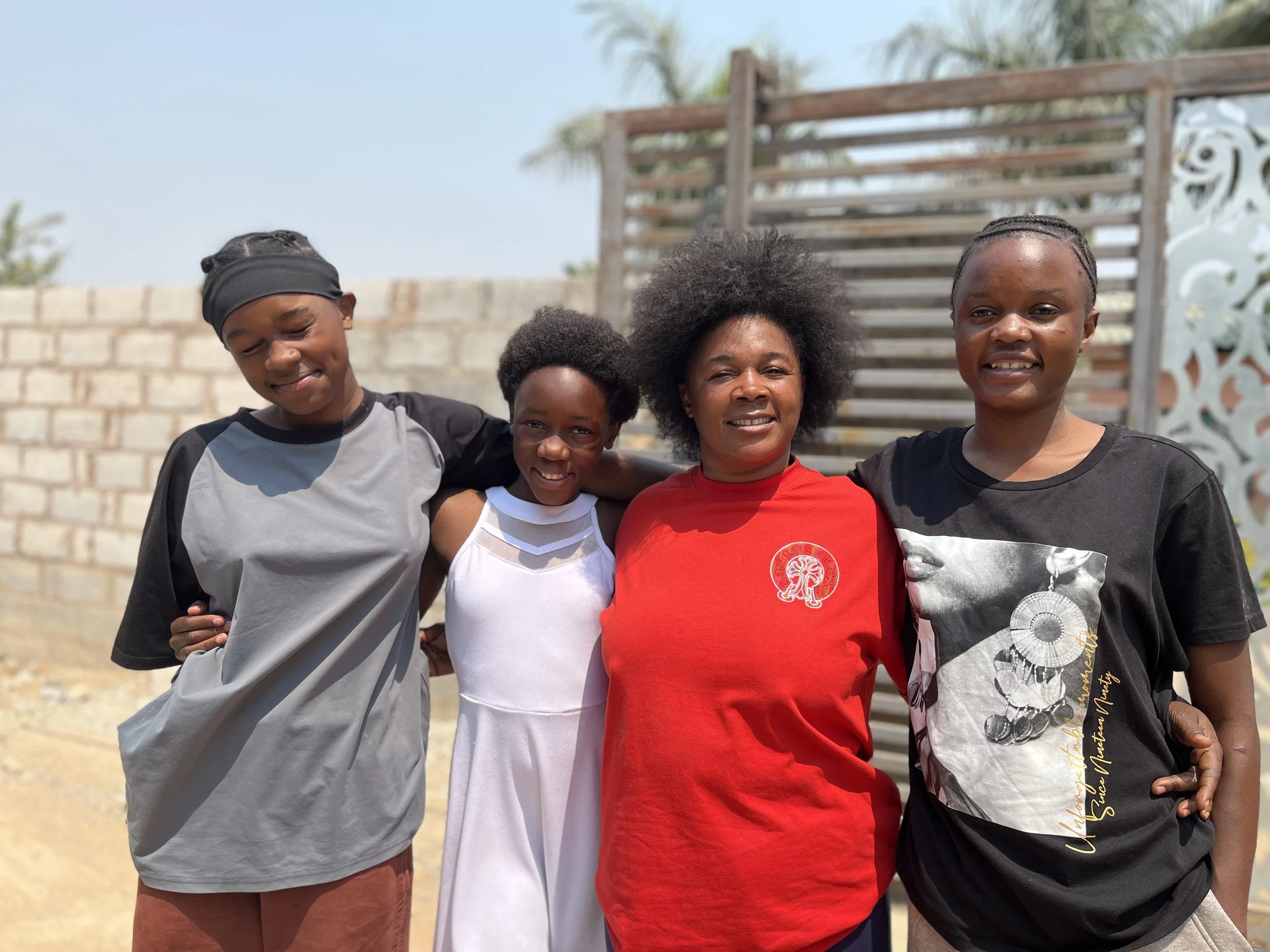 2026-09-34_Precious with her mother and sisters_AM.jpg