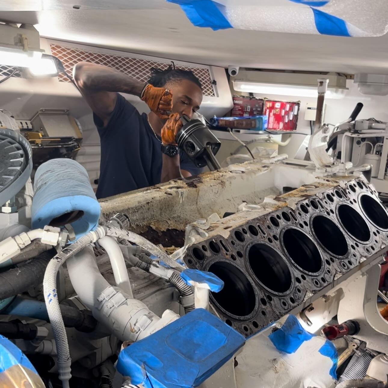 Hasa&rsquo;ani removing pistons during a scheduled overhaul of MAN V12 engines, thanks to our handy Scott Piston Puller!