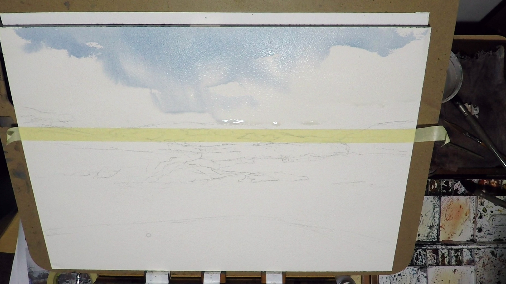 2. While it's still wet, I started to put in some Cobalt Blue, that will be the blue sky. Again I keep in mind the shape of the cloud. When the paint hits the wet area, it becomes a soft edge. When the paint hits the dry area, it'll be hard edge. Cl…