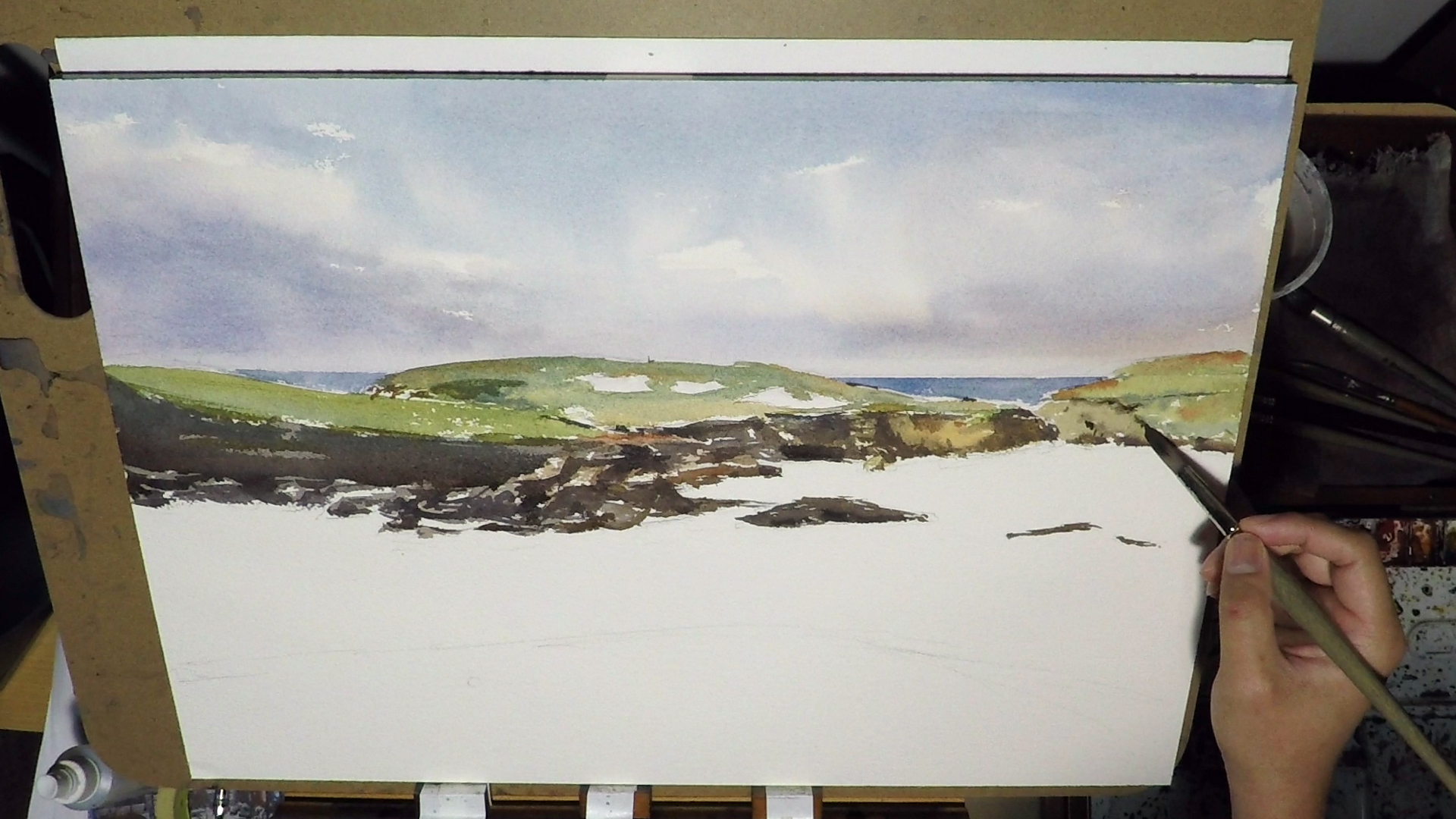 2. The tap removed, and we have a nice clean ocean line. I then started to paint the shadow of the rocks. The mixture should be more dry. Just add enough water to let the paint flows easily without getting watery.&nbsp;The light is from top down so …