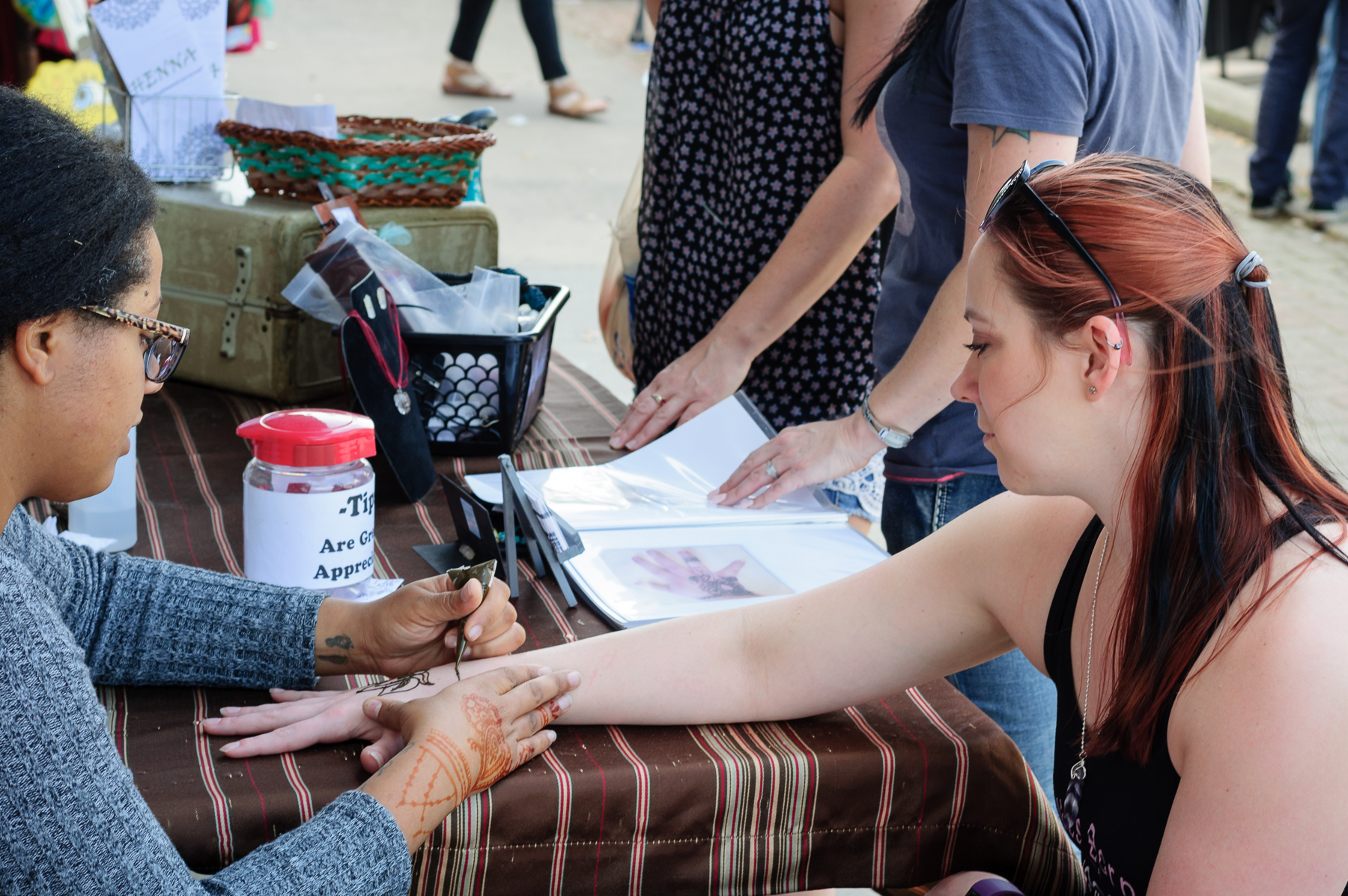 Lydia Pine applying henna tattoos during the event in downtown. It is a beautiful way to showcase body art without a permanent investment.