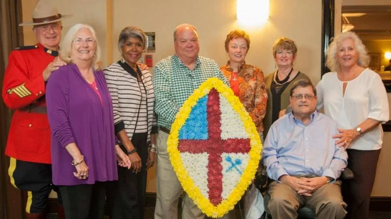 Greeted by the Royal Canadian Mounted Police and representing the Mark Emory Chapter of the Vergers’ Guild are (l-r) Ruth Anne Tatum (St. Martin's), Yolande Collins (St. Simon’s), David Neville (St. Simon's), Martha-Sue Blythe (St. Martin’s), Mary Nimsgern (St. James’), Bob Koppe (St. Bartholomew’s) and Cheryl Josephson (St. Martin’s). Photo: Alexis