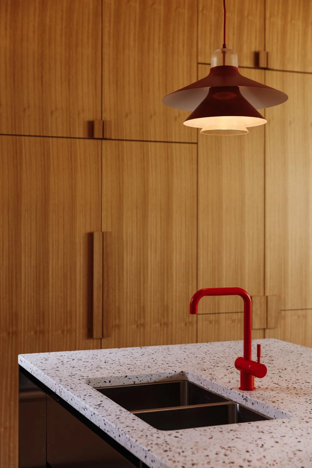 pops-of-redvia-the-louis-poulsen-lights-and-vola-tapare-a-nod-to-the-homeowners-favorite-hue.jpg