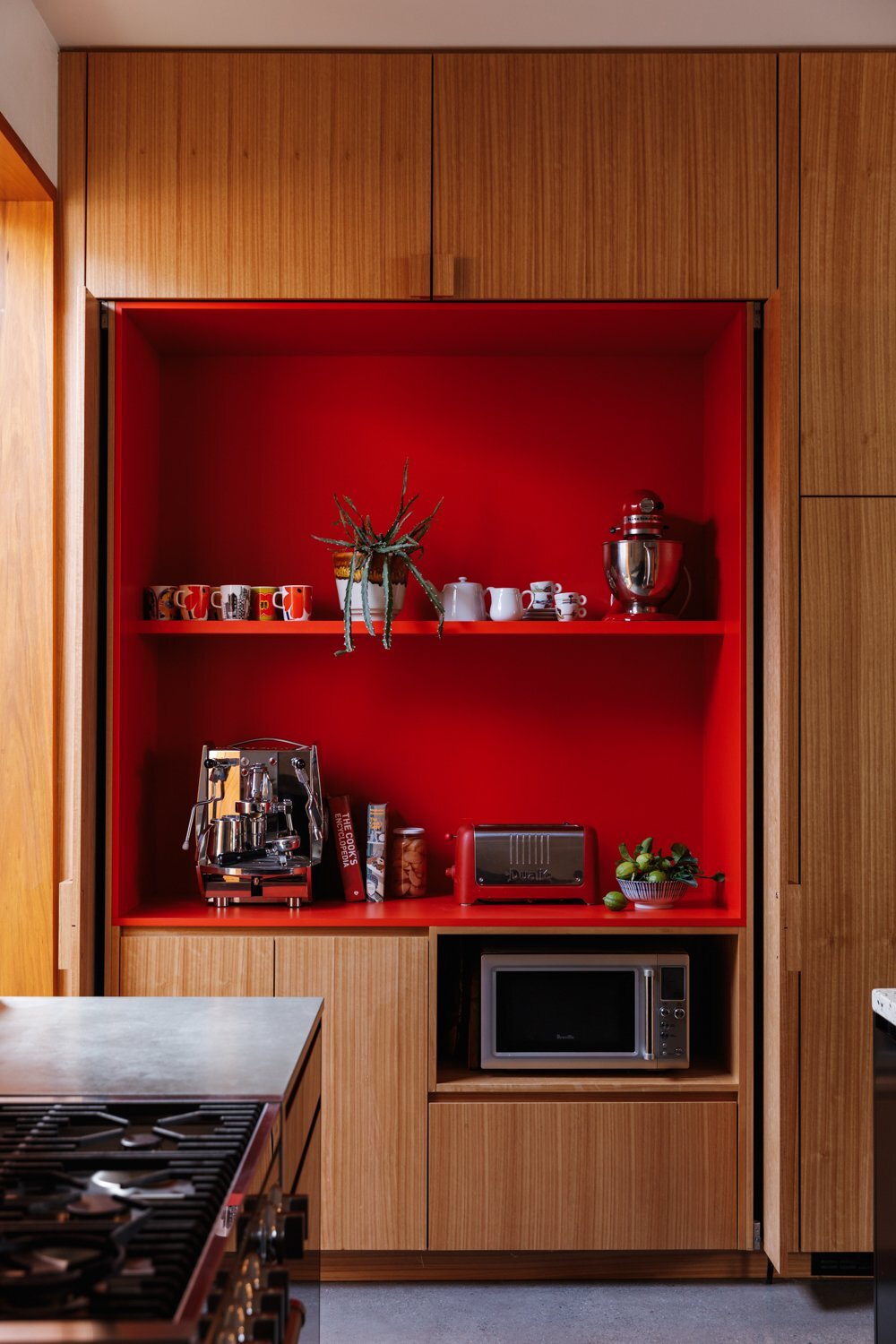 bright-red-laminate-shelves-hold-the-familys-coffee-supplies-in-a-delightful-reveal.jpg
