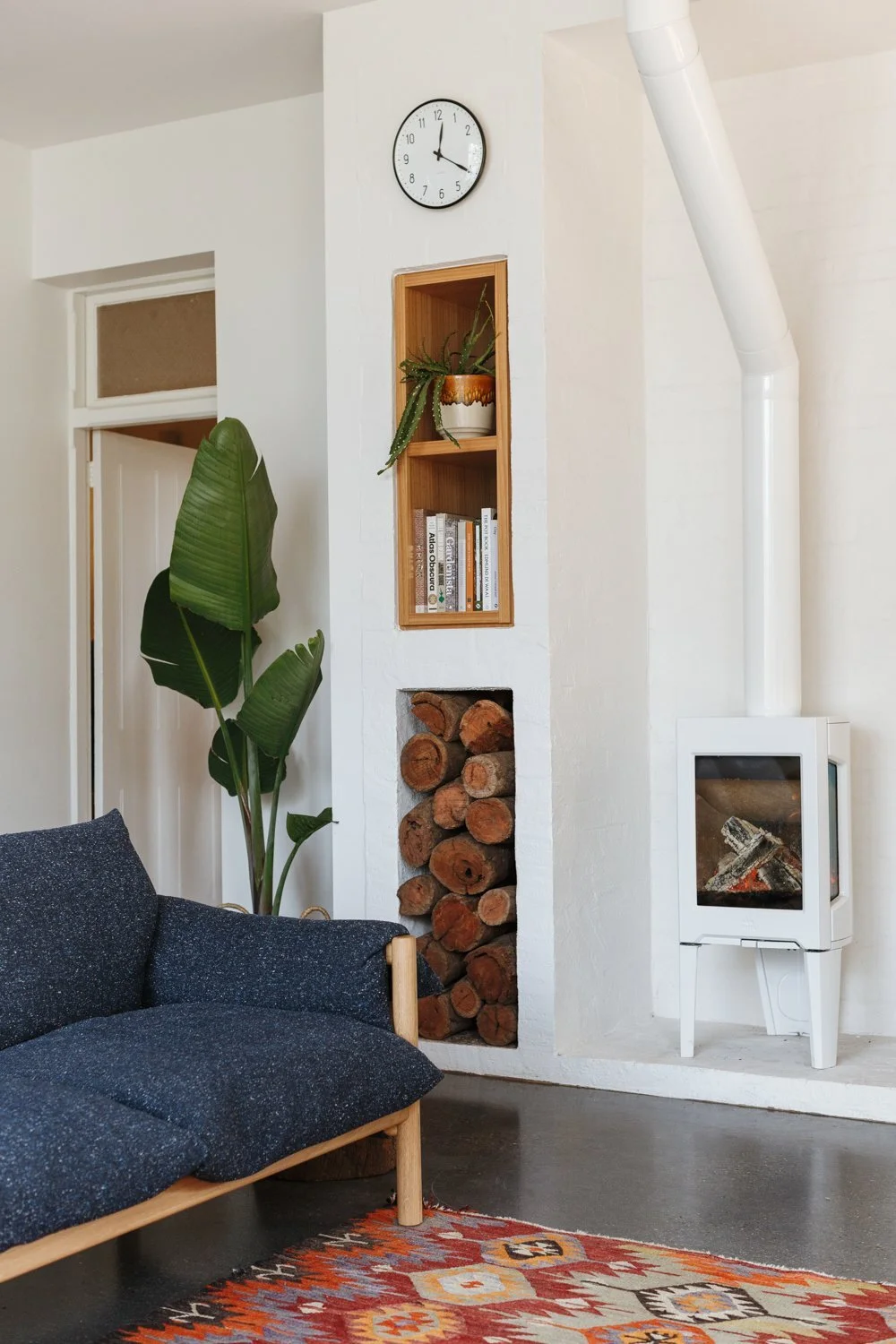 an-inset-shelf-is-a-decorative-feature-above-the-firewood-storage-we-enjoy-the-low-sun-in-the-winter-mornings-and-the-toasty-warmth-from-the-jotul-stove-which-heats-the-whole-back-of-the-house-say-the-clients.jpg