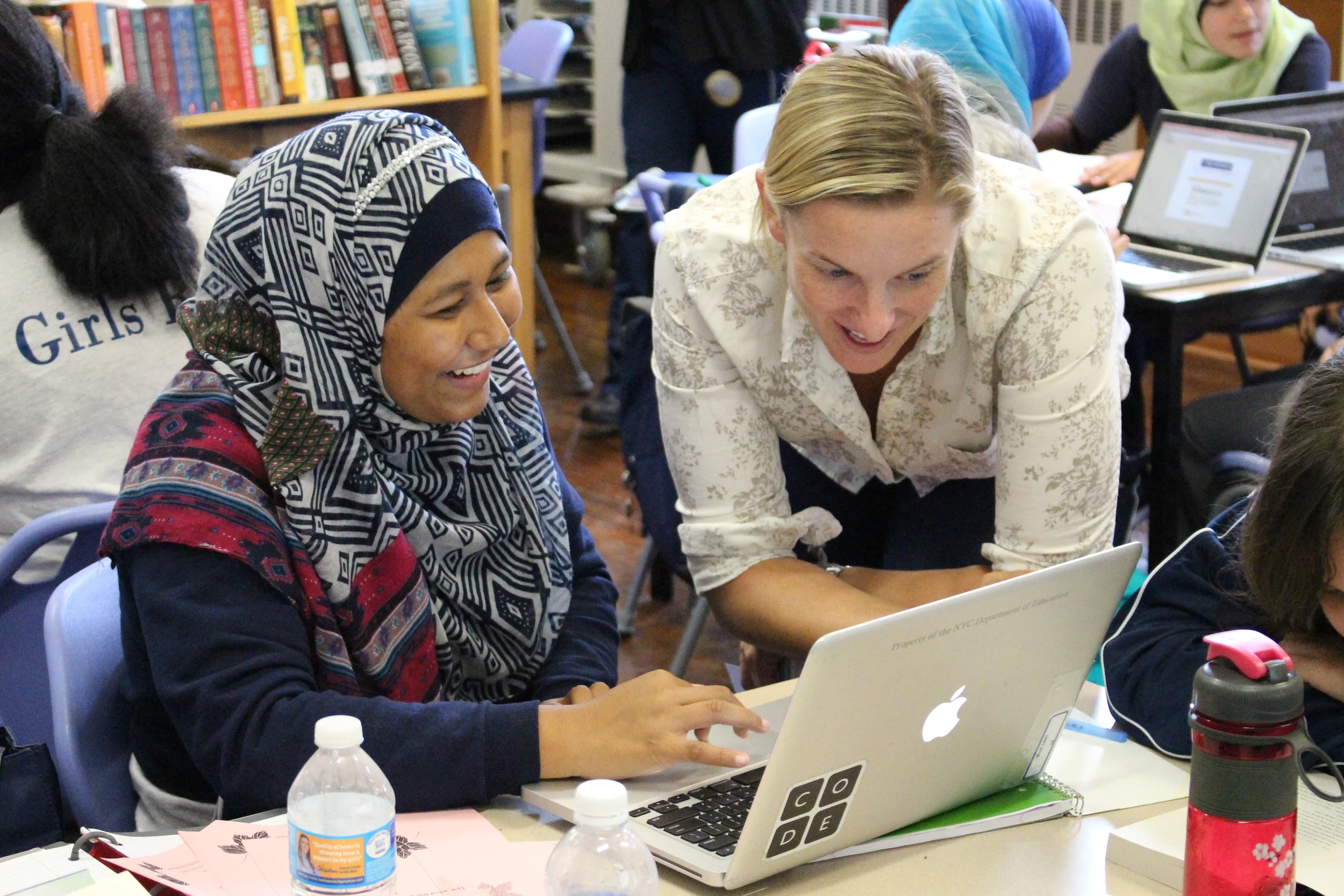 Teacher Christy Kingham and a student discuss her digital portfolio.