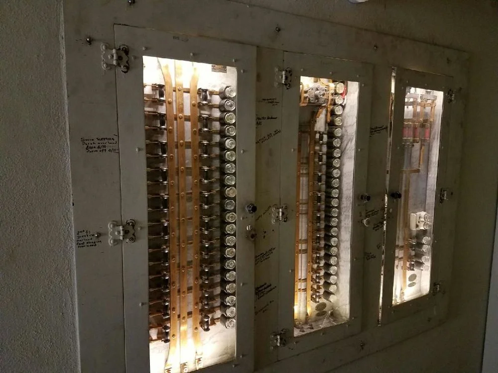 These custom built fuse panels are U.L Listed, have white marble enclosures, and glass doors. Installed 1918 in a new house for Robert M. McFarlin on South Carson in midtown Tulsa. When it was time to upgrade the system to breaker panels, the current owner did not want to remove these beautiful works of art and us at Alrac Electric were glad to hear it. The fuse panels are now non-operational but we installed some LED lighting inside that shine 24-7. For visual purposes these look just as they did when they were the main power for house, located in the basement hallway.