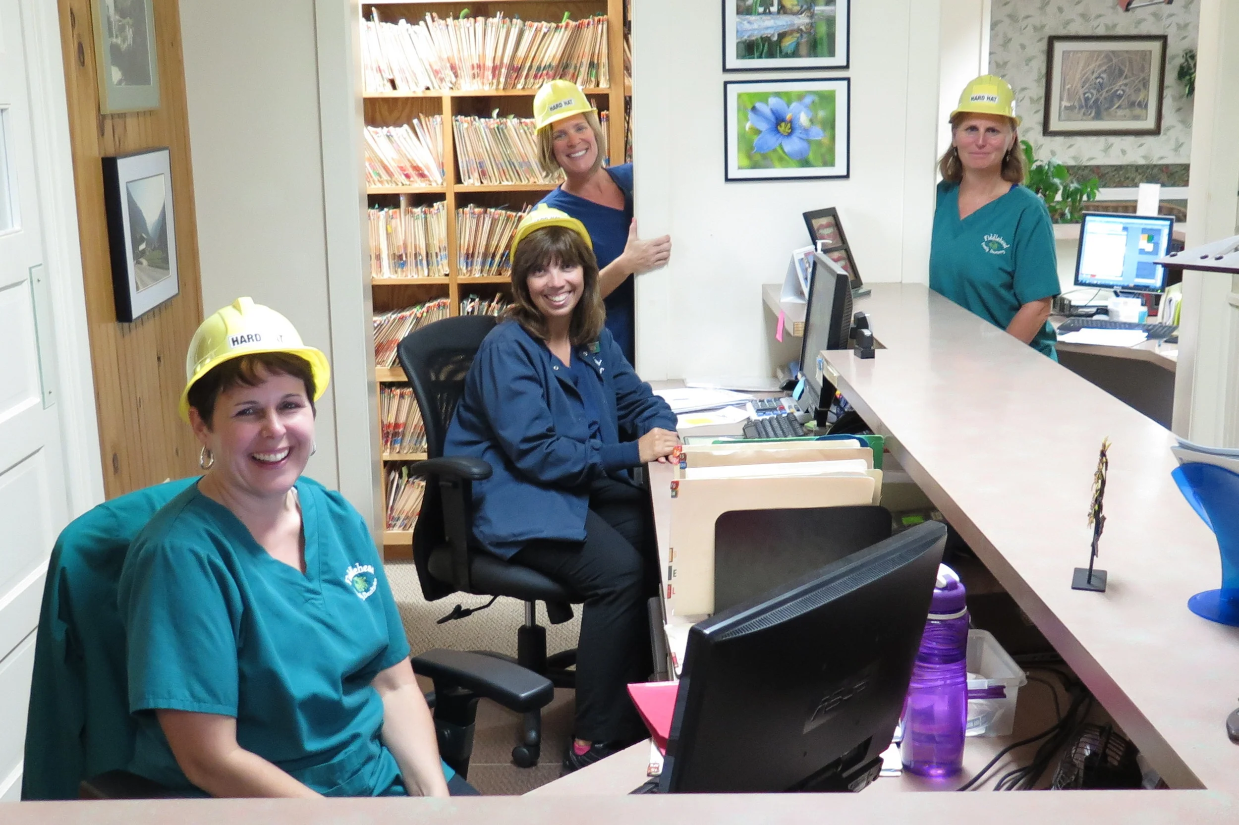the team wears their hard hats for fun on the day that we had almost no septic access. This is typical of our team: making lemonade out of lemons!