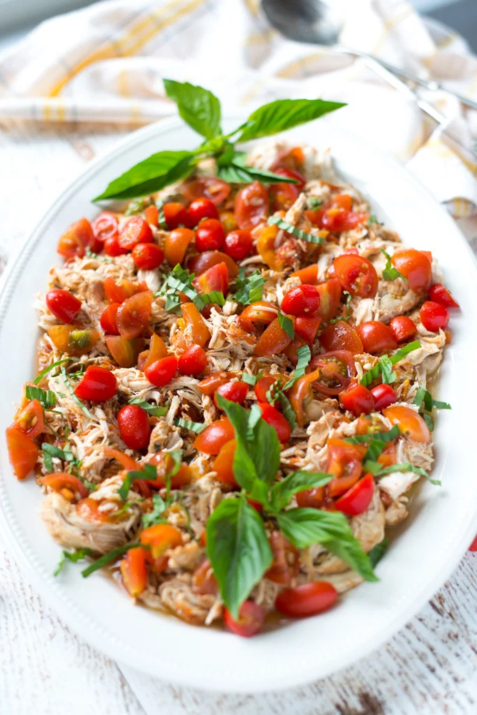 Light, bright, and perfect for summer, Slow Cooker Balsamic Tomato Basil Pulled Chicken is super easy to prepare and so delicious.