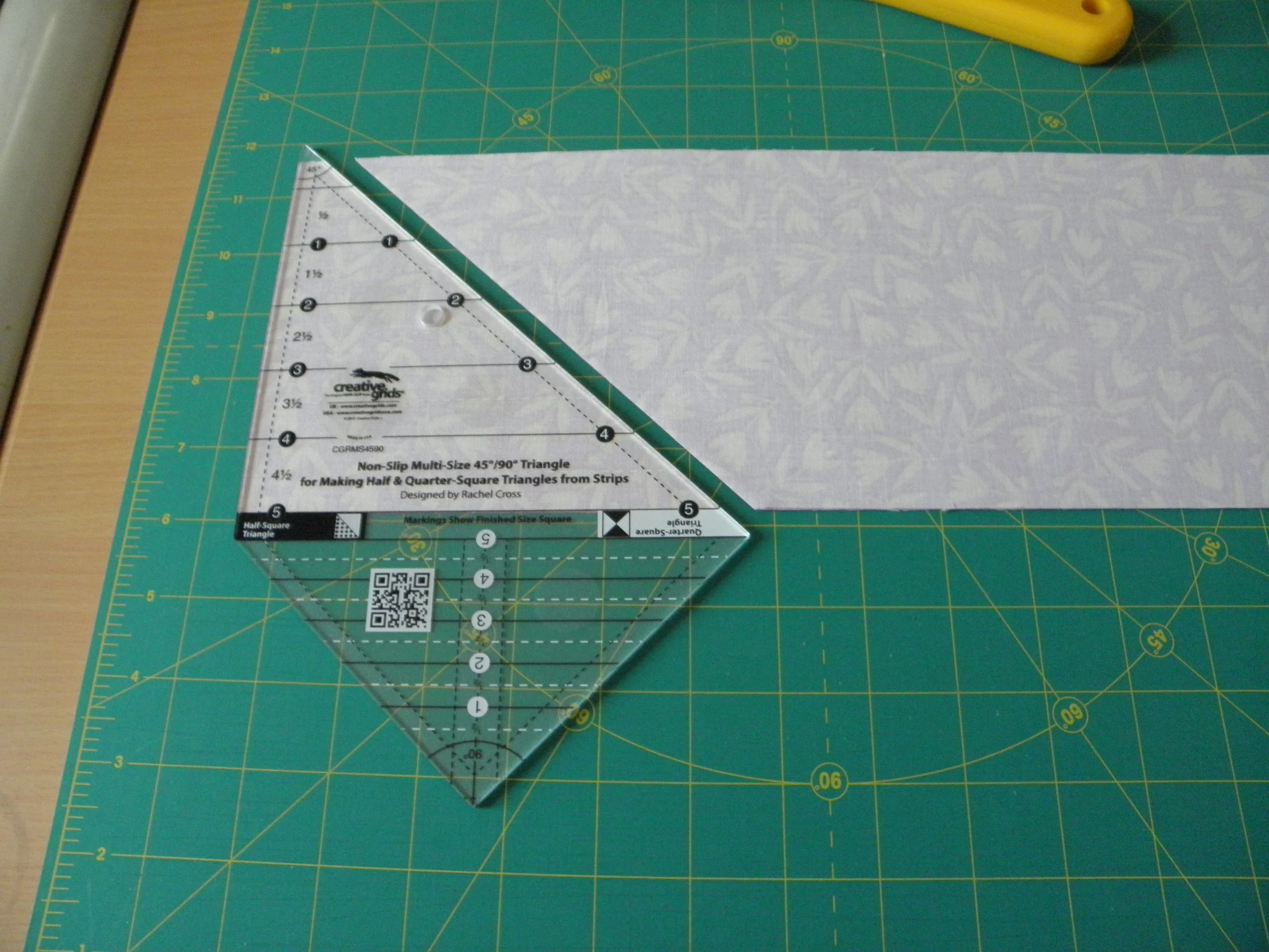 Line up the strait side of ruler to trimmed edge of strip set.