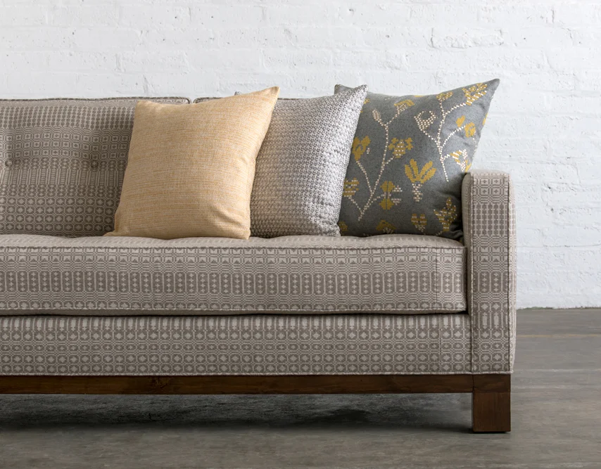 Sofa and cushions upholstered with some of the Undaunted collection fabrics.