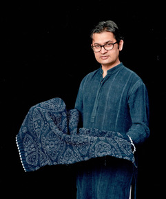 Abduljabbar Khatri Artist Jabbar is an artist, born and raised in northwestern India, in the town of Kutch, to a family with a long and storied tradition in bandhani . This unique technique involves dyeing a fabric which has first been tied tightly with a thread at several points. The tied points resist the dye and as a result producing a stunning and varied pattern. For centuries the Khatri family had been involved in the craft of bandhani, but the link was broken when his great-grandfather left the business to make fireworks for the royal family. Jabbar and his brother, Abdullah, revived the family tradition under the name of Sidr Craft . The business provides livelihoods for about 250 artisans in India. Jabbar has worked with leading fashion designers developing new dyeing techniques and Sidr has participated in workshops and exhibitions in Japan, France, Hungary, Portugal, Malaysia, Canada, Holland, the UK and the US. Sidr has participated at the Santa Fe International Folk Art Market since 2007; and in 2017 Sidr Craft won the “Living Traditions Award”. sidrcraft@gmail.com