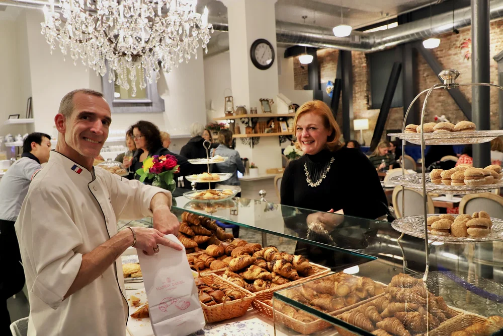 Danel filling a bag with croissants.jpeg