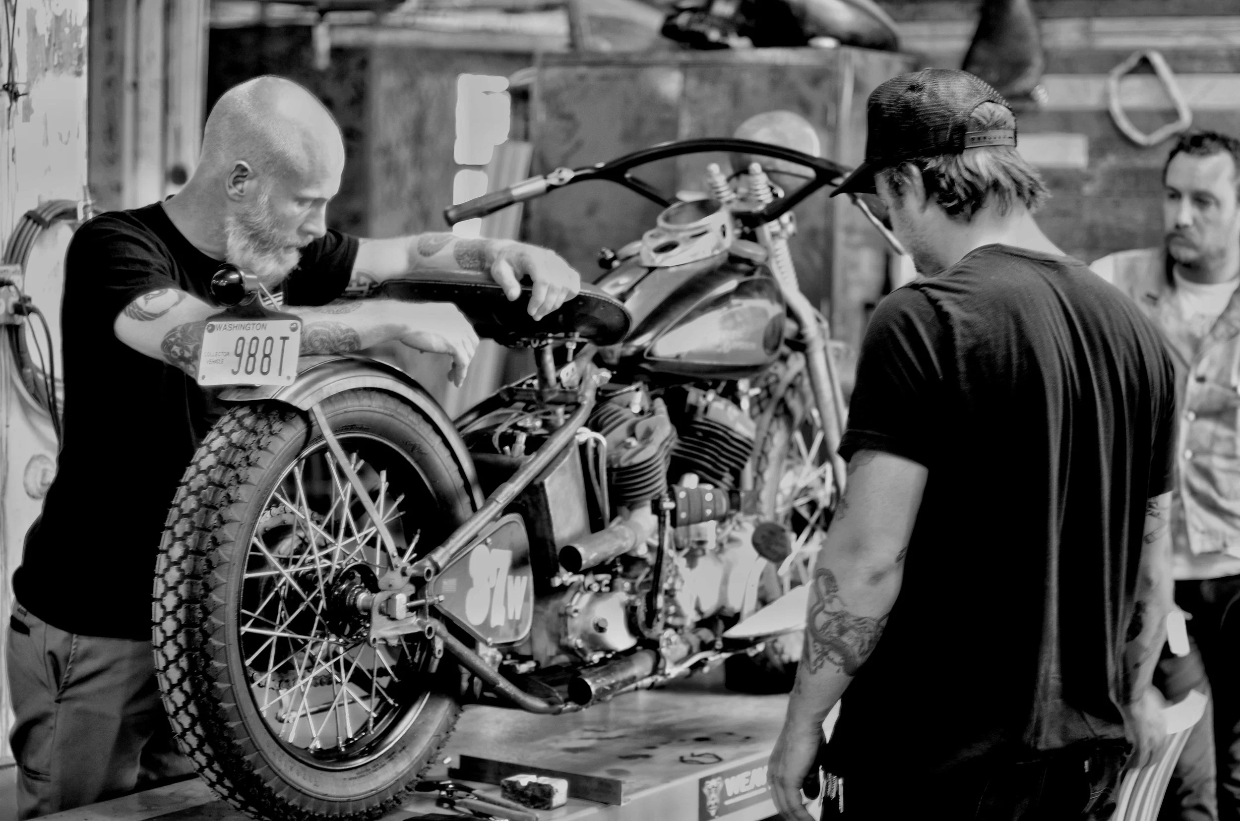 Working on the Black Bear Brand’s 1937 Harley Davidson in Milwaukee, Josh Sirlin with Alex Jannke during the Our American Journey ride across the country. Photo by: Chad Lyons