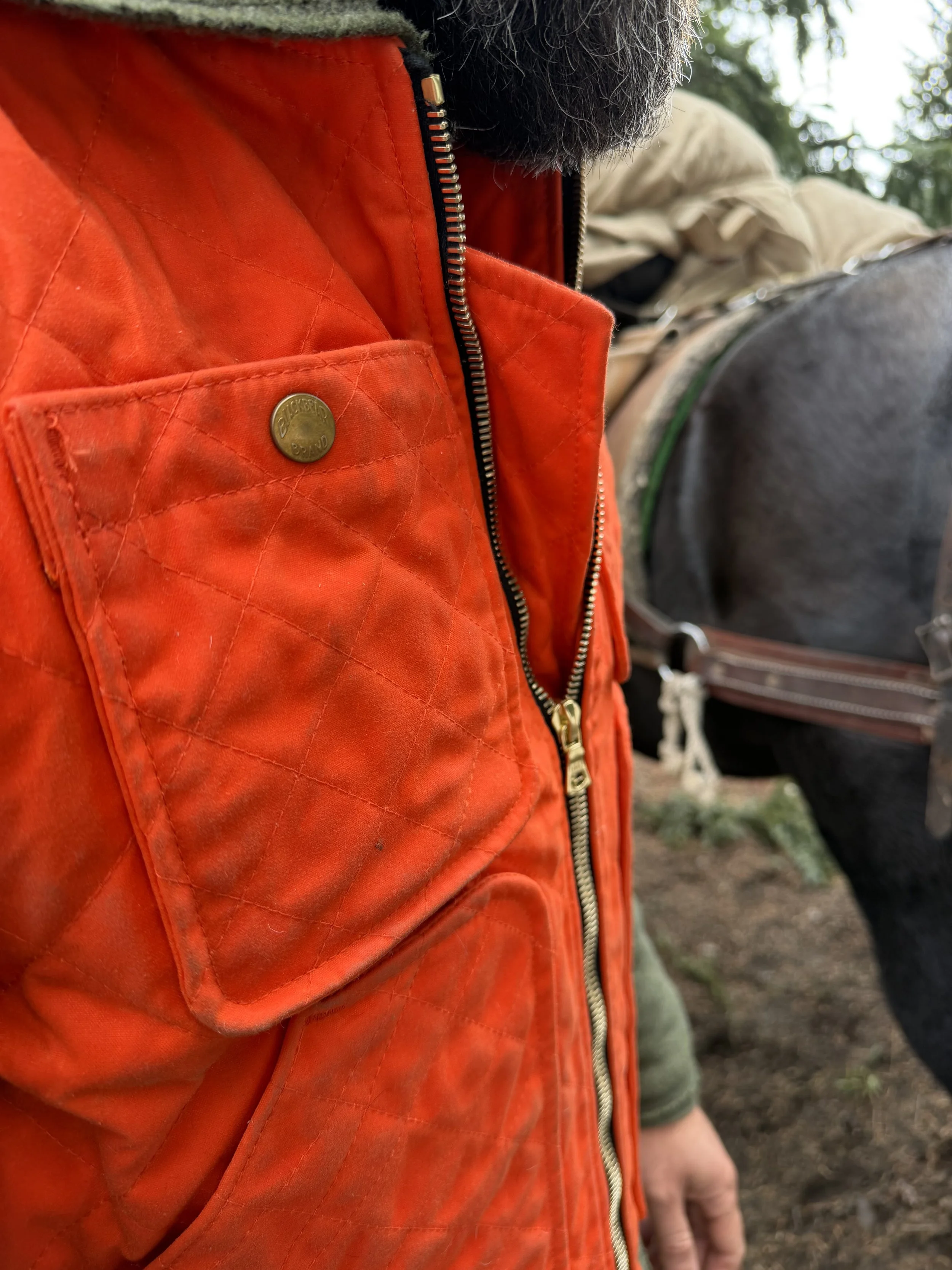 world famous hunting guide Cliff Gray wearing the Black Bear Brand HUNTING ORANGE collaboration Wax Canvas... Quilted by Hand - Ultimate Vest on a hunt.