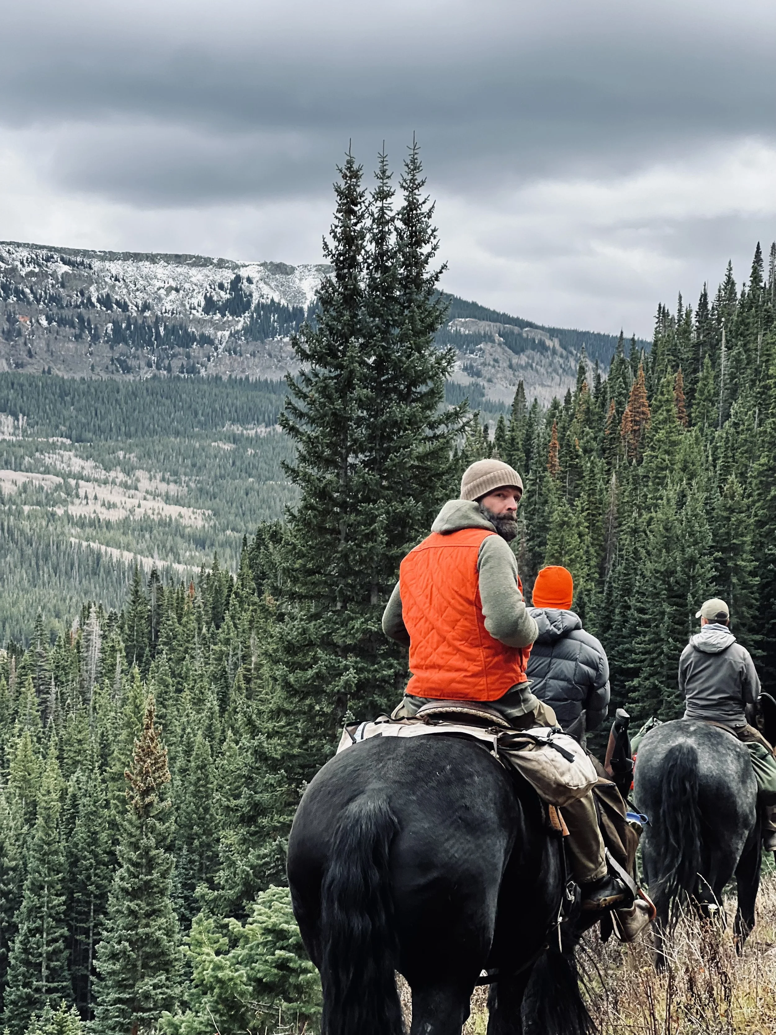 world famous hunting guide Cliff Gray wearing the Black Bear Brand HUNTING ORANGE collaboration Wax Canvas... Quilted by Hand - Ultimate Vest on a hunt.