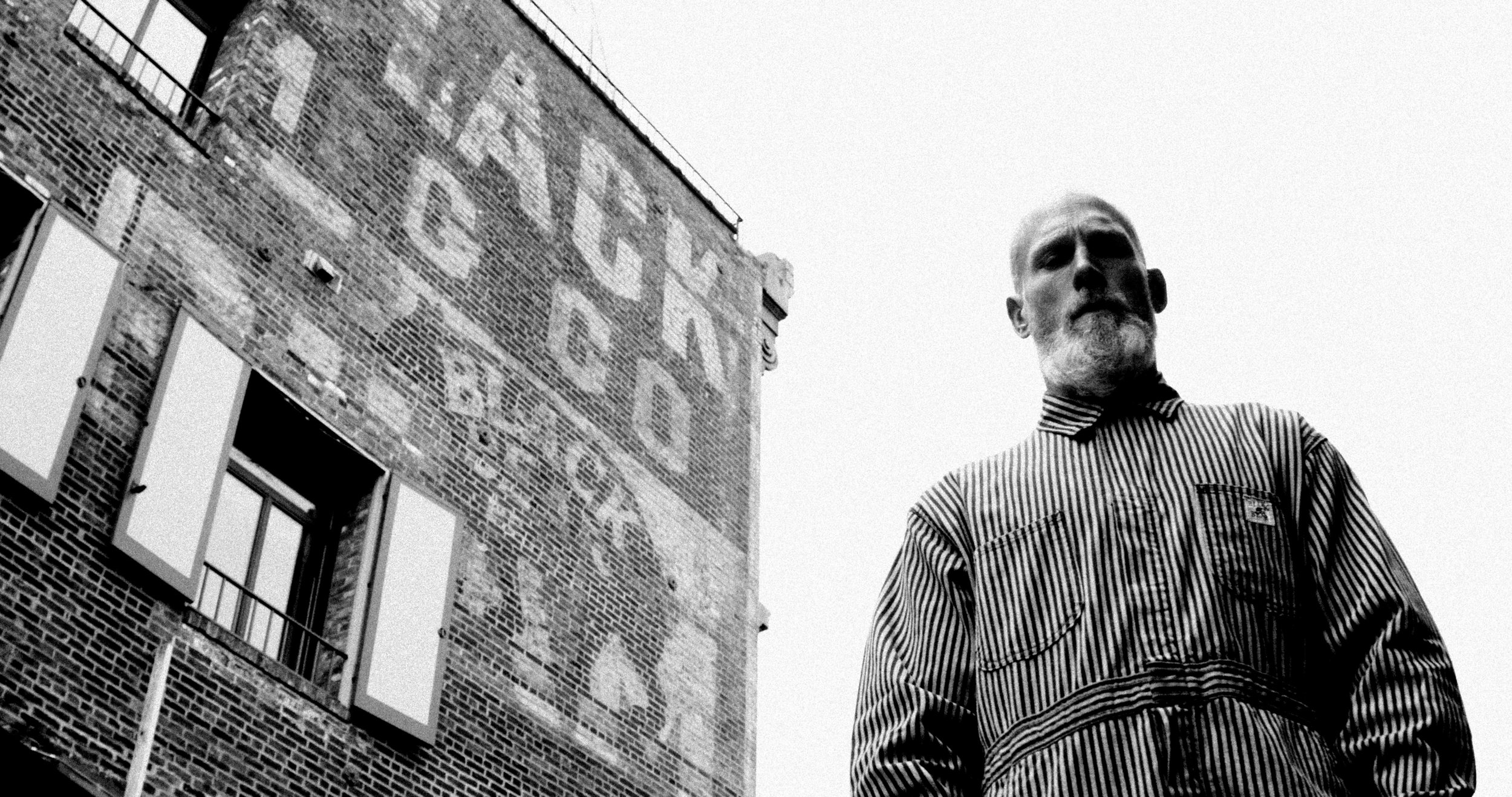 Faded painted Black Bear Brand ghost sign on a Seattle brick building.JPG
