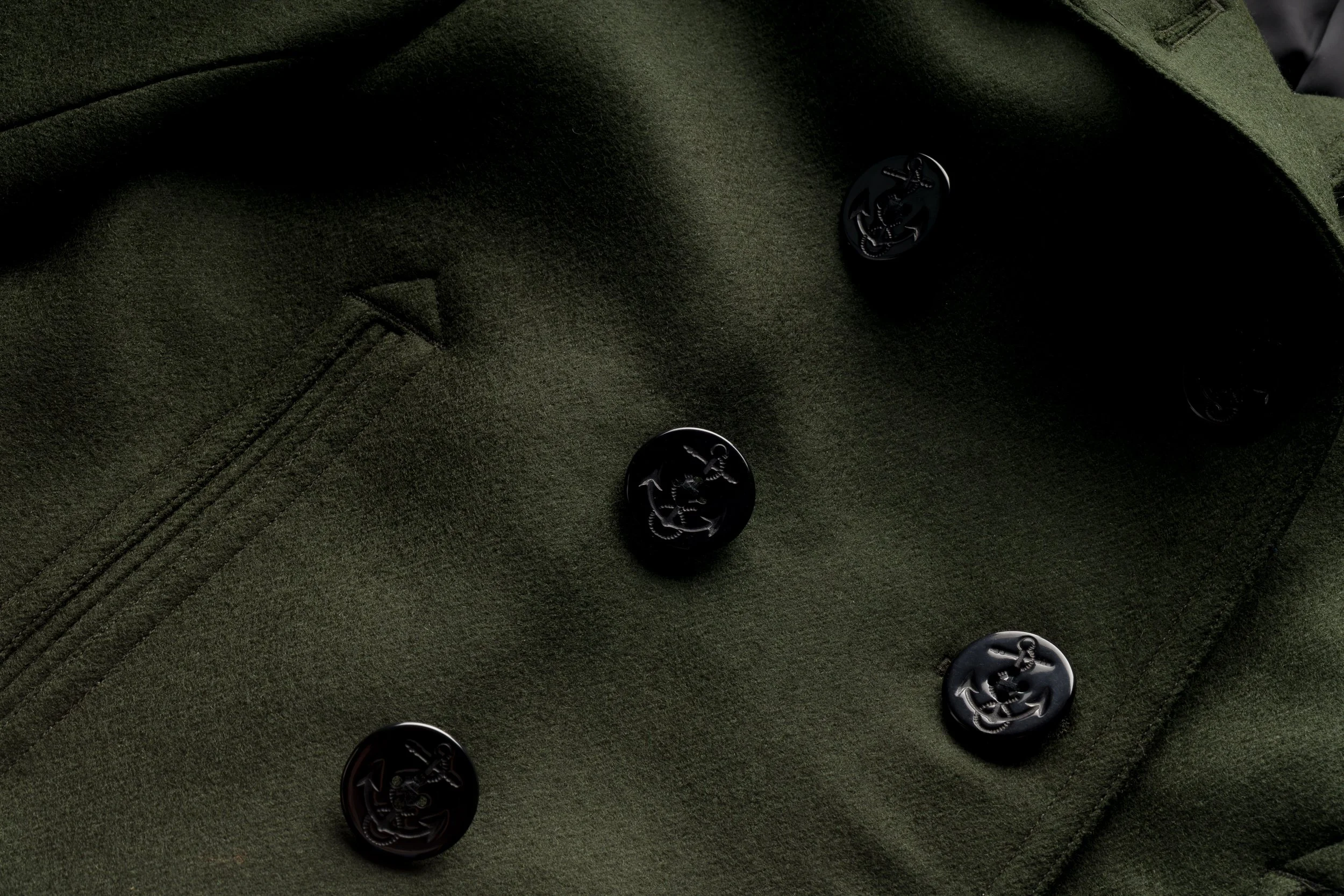 Detail view of the Black Bear Brand Hunter Green Peacoat’s double-breasted front and pockets.