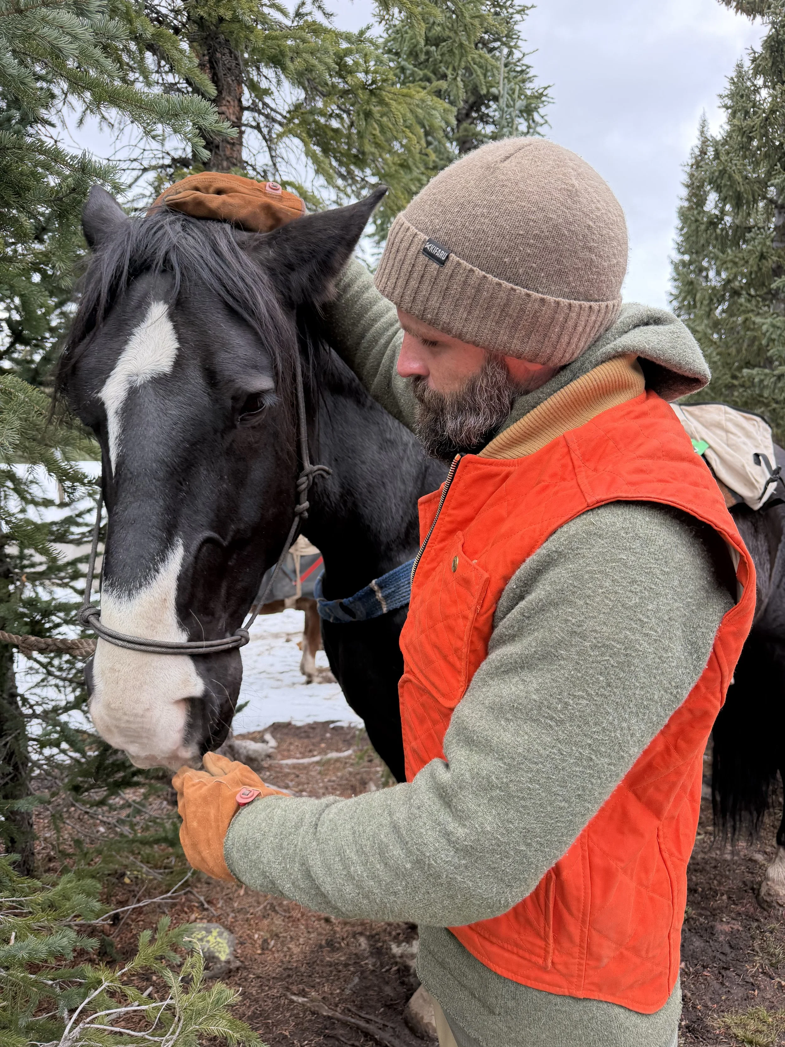 world famous hunting guide Cliff Gray wearing the Black Bear Brand HUNTING ORANGE collaboration Wax Canvas... Quilted by Hand - Ultimate Vest on a hunt.