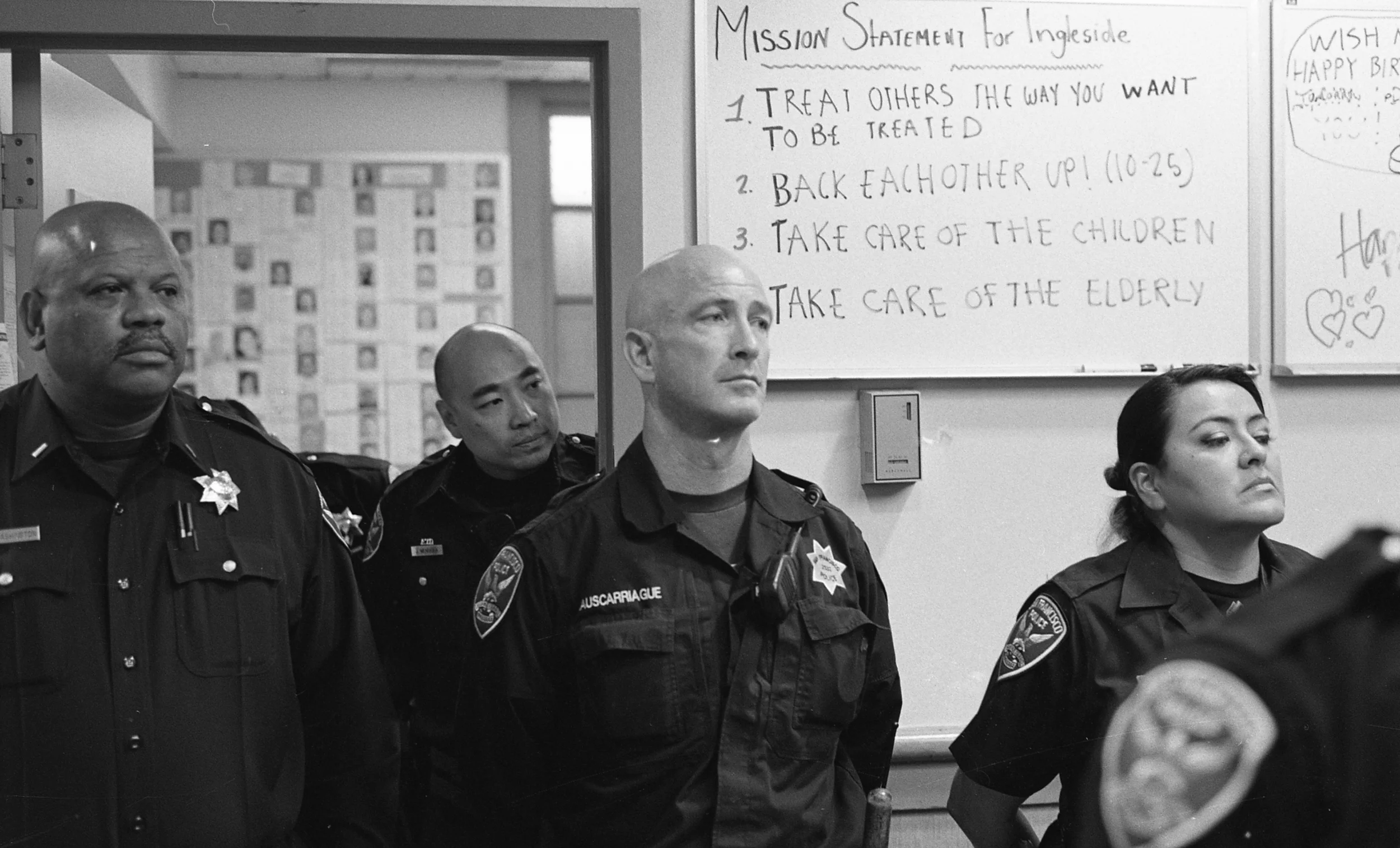 During midday lineup, officers at Ingleside station listen to Captain Joe McFadden as he updates his officers on recent events, including the forced resignation of Chief Greg Suhr two days before and the appointment of interim Chief Toney Chaplin. At the beginning of every shift, officers lineup for attendance and series of announcements from the commanding officer, usually a lieutenant in charge of day-to-day station operations.