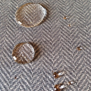 Above:  Example of water beading on a fabric likely coated in PFC&nbsp; Chemicals for the purpose of stain resistance.