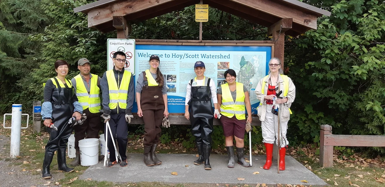 Volunteers of the Hoy/Scott Watershed Society stand near the information sign on Runnel Drive.