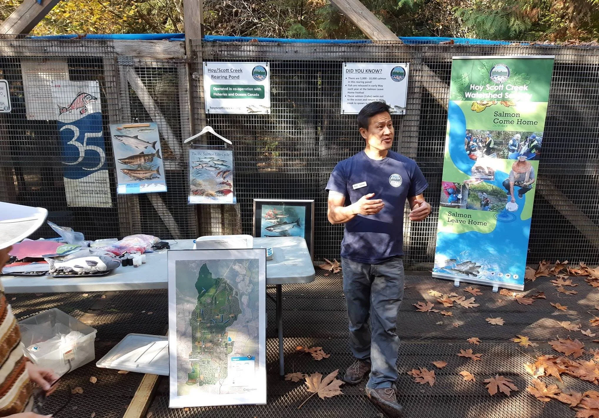 Hatchery manager, Rodney Lee providing a talk on the salmon life cycle in 2018 in front of the hatchery rearing pond.