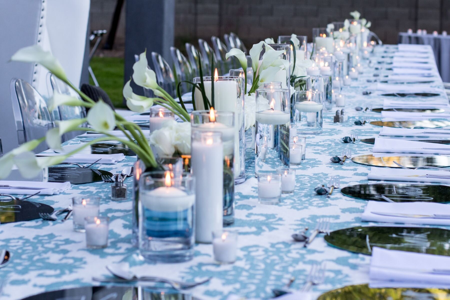 1 white and blue printed table linens short and tall white candles floating white candles simple white flower centerpieces simple centerpieces gold chargers James Barnett Photography Life Design Events.jpg