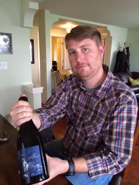 Dunahm winemaker w bottle of artist series.JPG