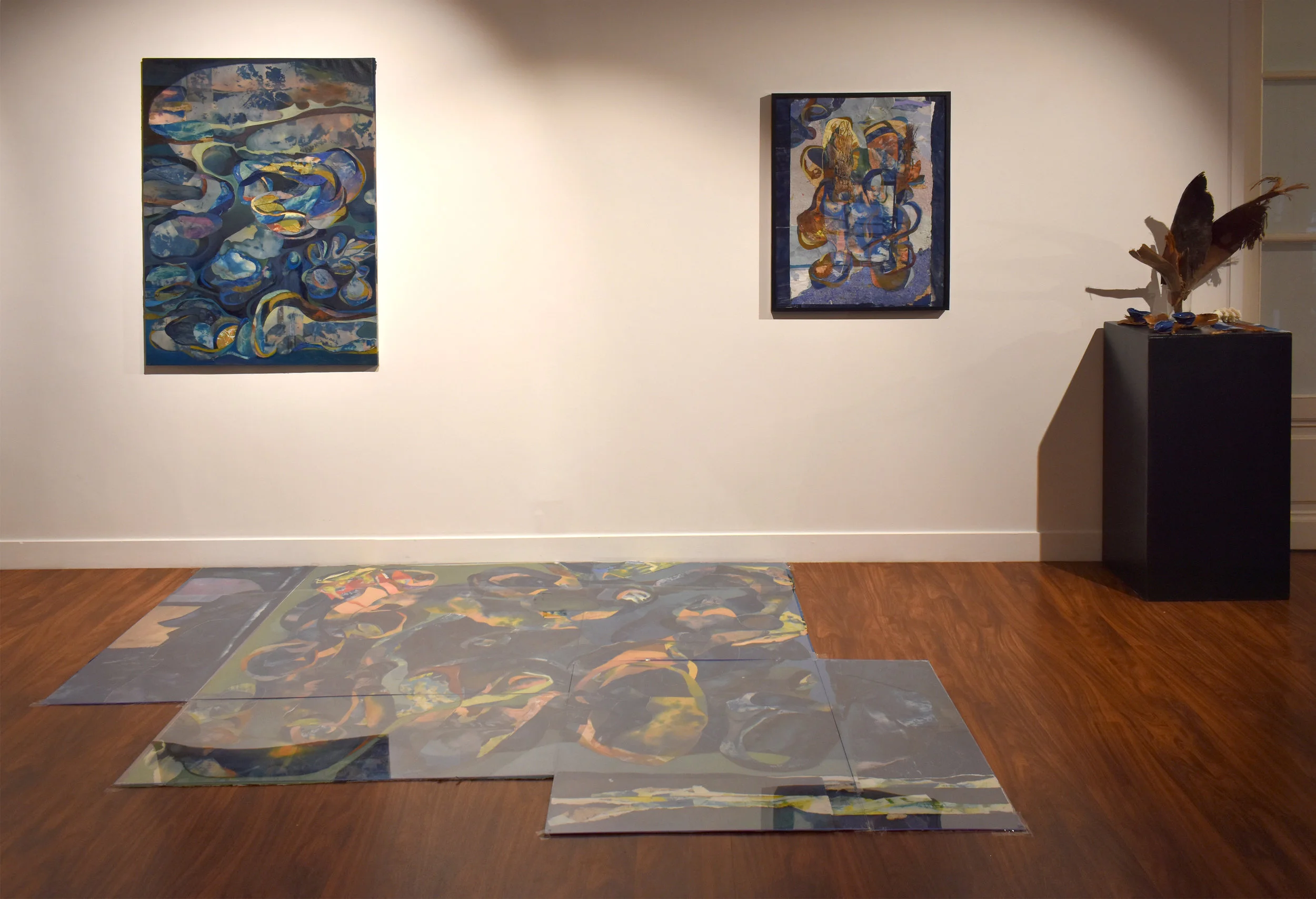 INSTALLATION: Unfurled as a floor installation under plexiglass, along with Looped (left) and Study for Unfurled (right) and Altar for Unfurled : revealing the natural materials (palm tree bark, platycerium leaves, Icelandic rock, hand-made ceramic vessels, cyanotypes of the human cerebellum) that inspired/generated the painting. The choice of a floor composition presents the three works as a continuous, cyclical whole— a stage in the process of recycling paintings and natural materials. Floor composition inspired by Italian mineral marqueterie.