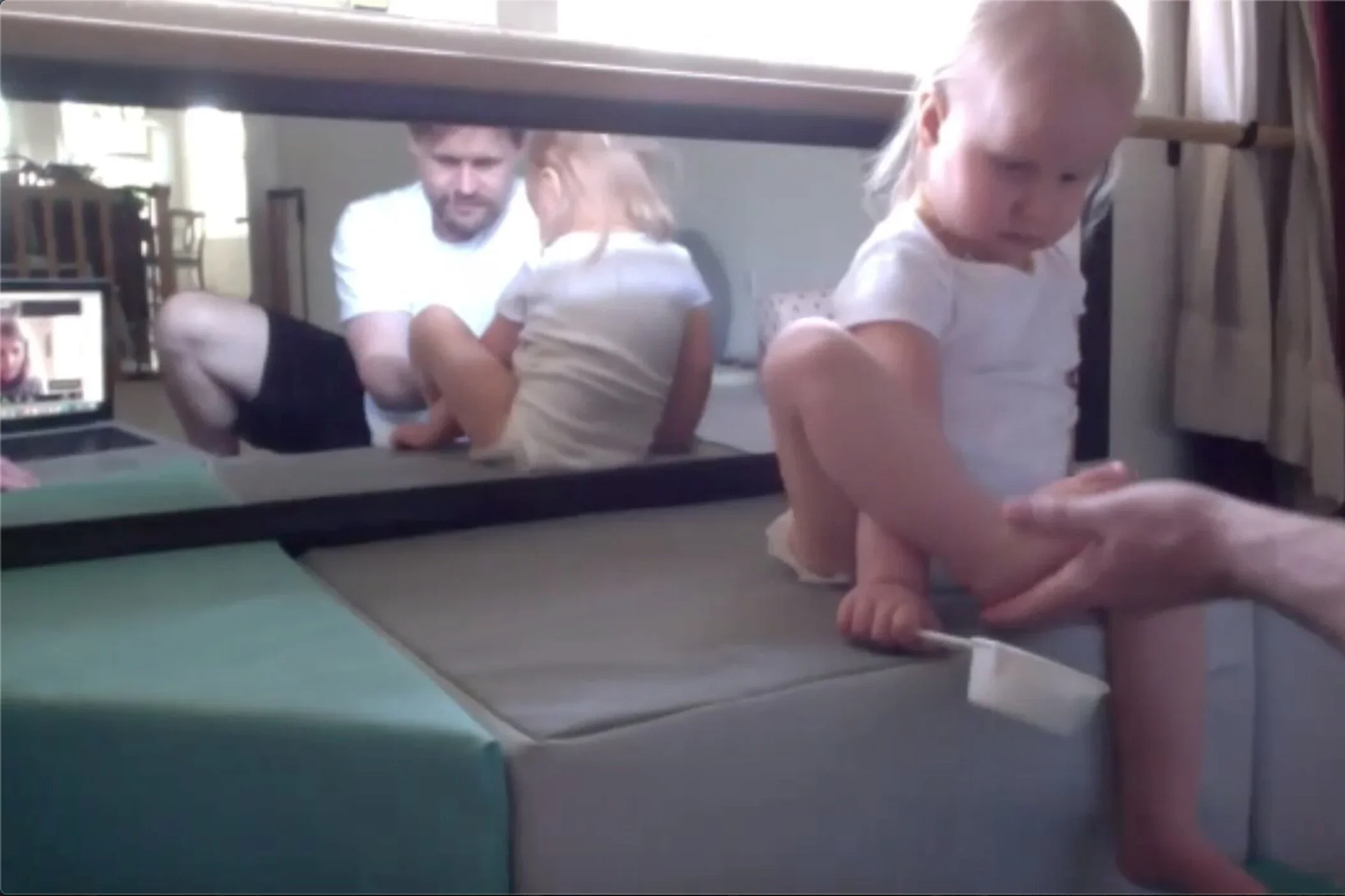 Father playing with his daughter in an online NeuroMovement  Parent Coaching session with Birgit Jung-Schmitt