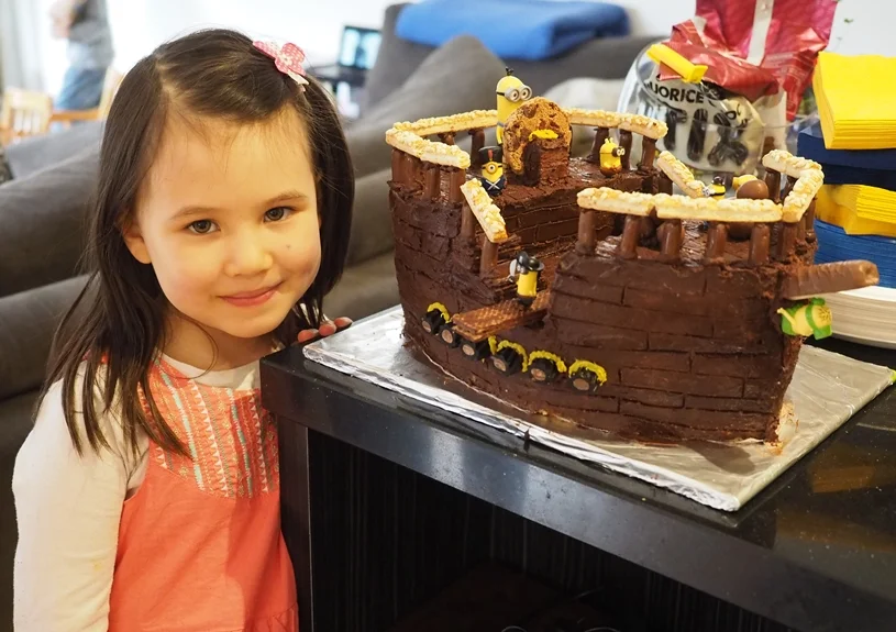 Gorgeous Erin with the minion pirate ship cake that her amazing mummy made her!! 