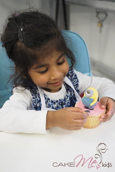 A five year old proudly creating her minion