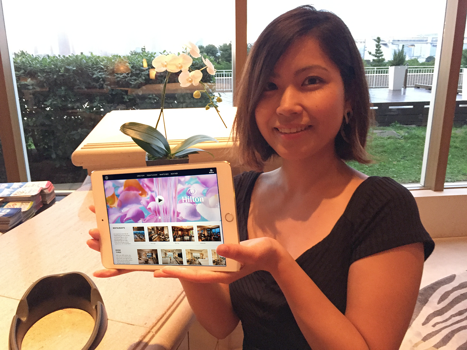 Showing off the Hilton Tokyo Odaiba mobile app near front desk.