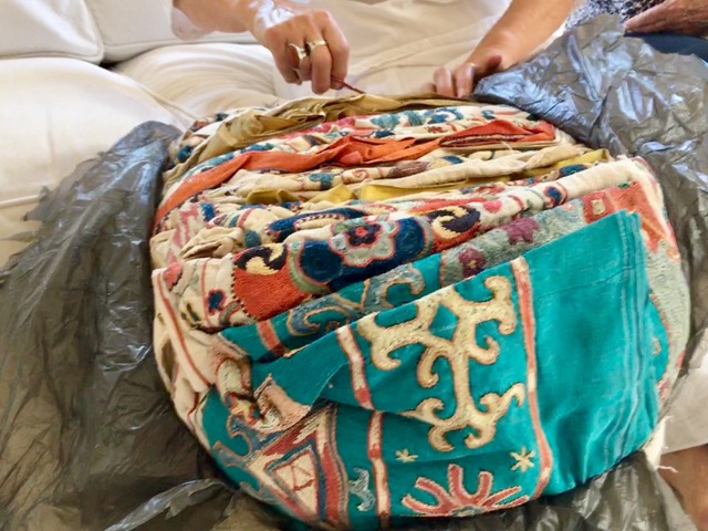 A Suzani parcel takes months to get to Cape Town and they have to be very well protected within the hand sewn cloth bag with the wax stamps on it. Cutting away at the plastic is a delicate challenge.