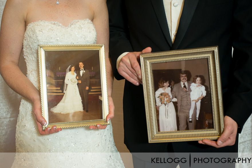 holding parents wedding photos on wedding day