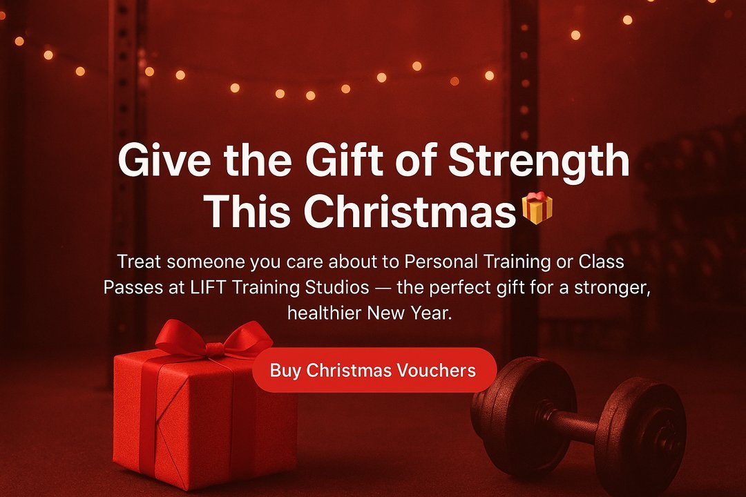 Festive gym scene with warm red lighting, a wrapped Christmas gift box and a dumbbell, promoting LIFT Training Studios’ Christmas fitness vouchers.