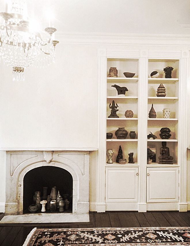 SHOT TAKEN OF ONE OF THE TWIN FIREPLACES WITH A BEAUTIFUL MARBLE SURROUND