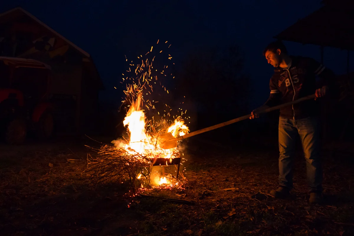 Ucha preparing a traditional Georgian BBQ with branches from the family vineyard.