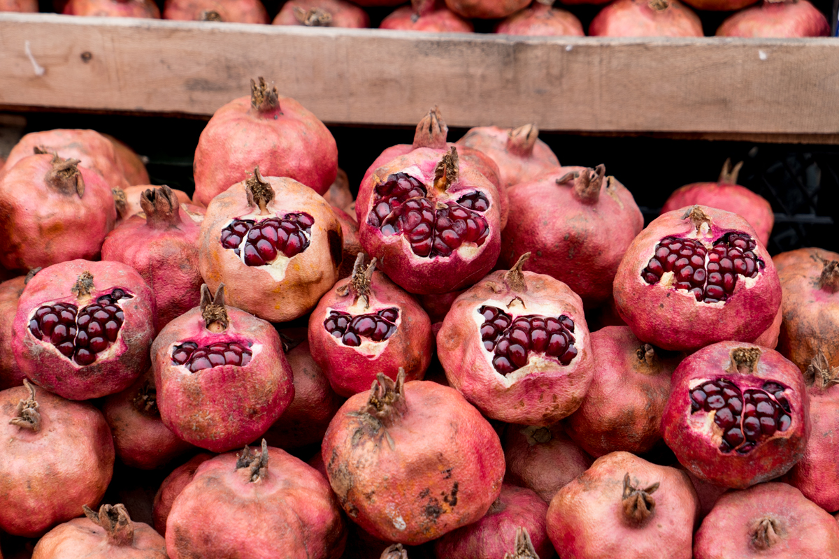 Pomegranates stacked and ready to sample at the market.