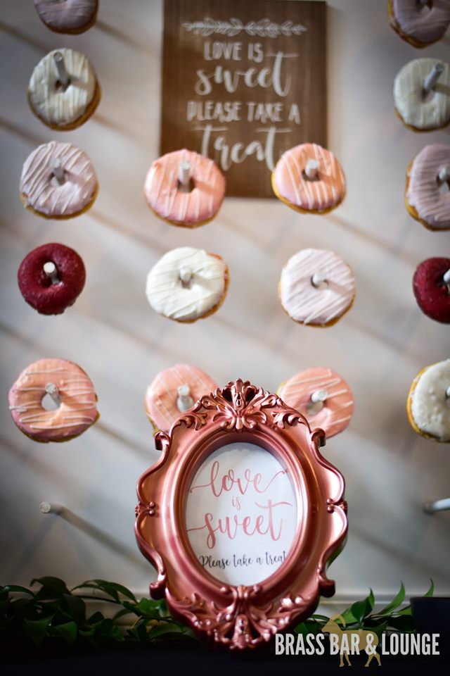 A closeup view of a donut wall with a framed quote in front of it.