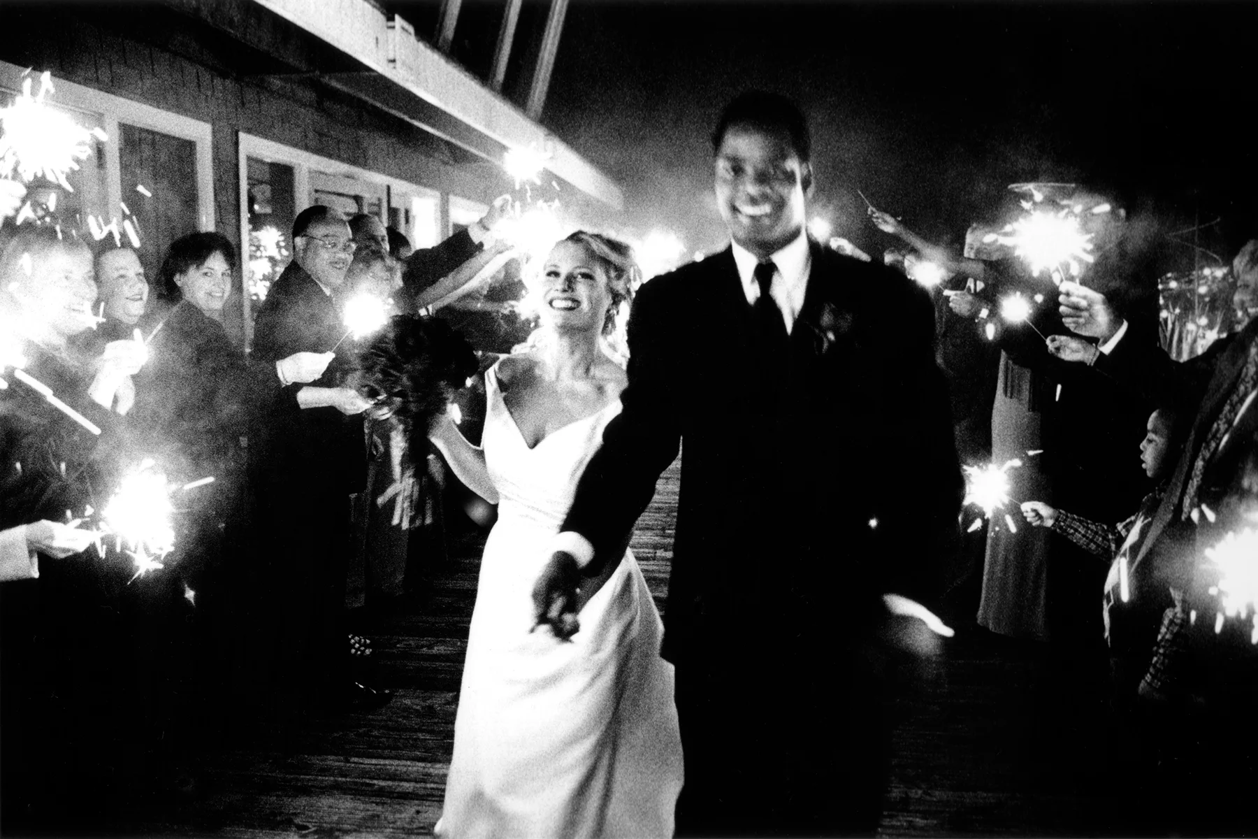 Sparkler exit at midnight at Salty's in Seattle, WA. This was a winning image in PDN (Photo District News) "Top Knots" wedding photography contest in 2004.